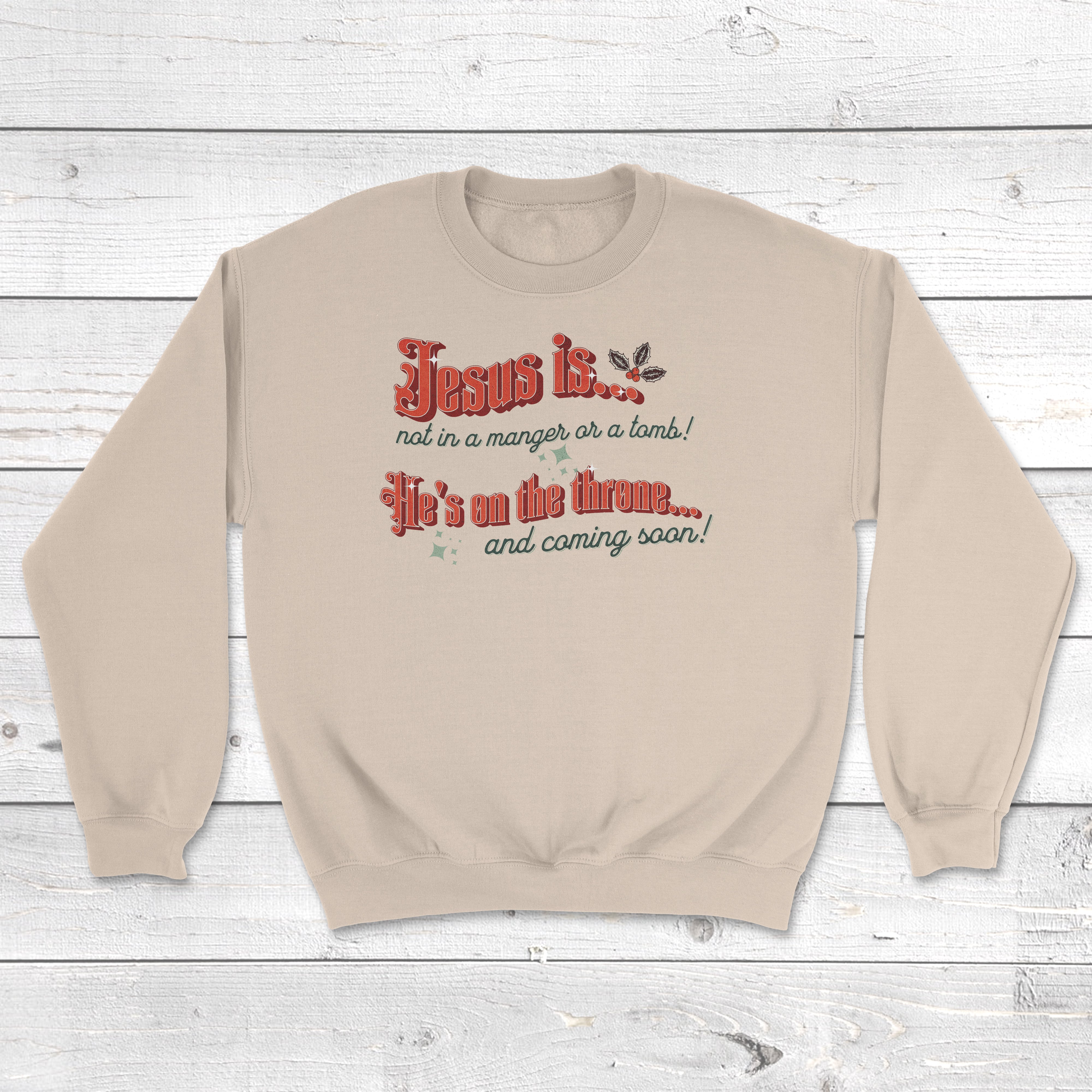 Jesus is not in the manger sweatshirt in sand